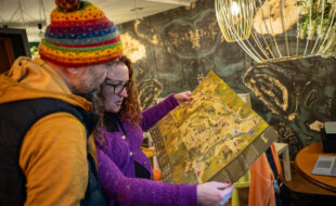 Zdjęcie dwóch osób oglądających rozłożoną mapę.